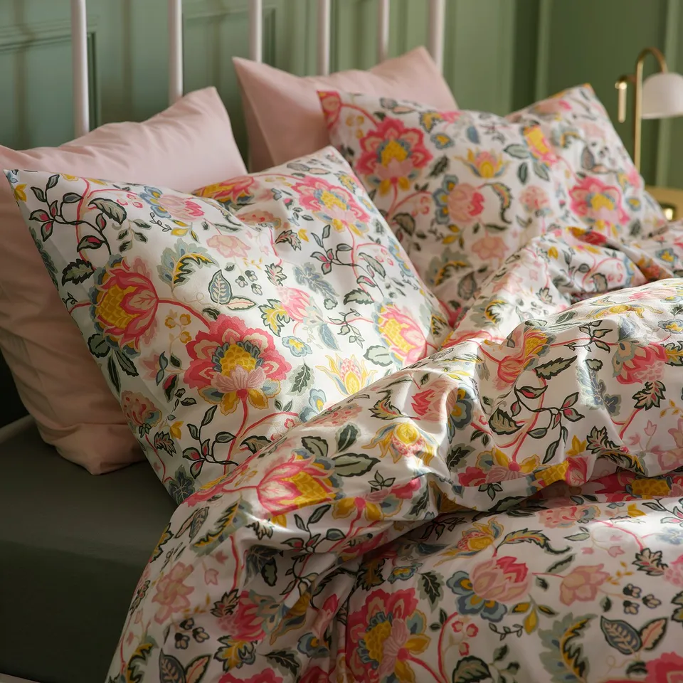 Bright floral bedding set, smooth fabric, colourful patterns on pillows and duvet.
