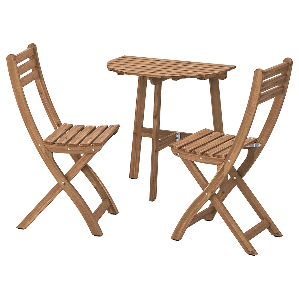 Acacia wood outdoor dining set with table and 2 folding chairs, plus cushions.
