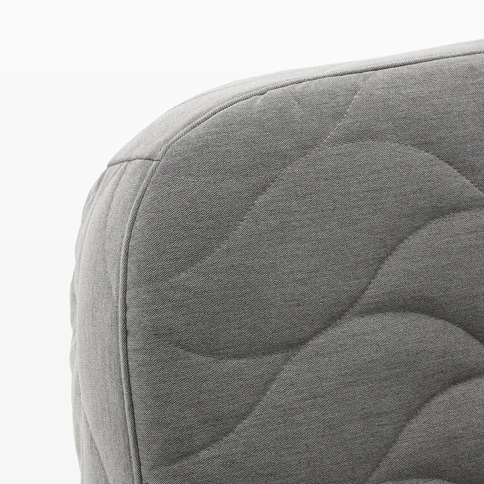Grey fabric sofa section, smooth texture, clean lines, cushioned backrest.