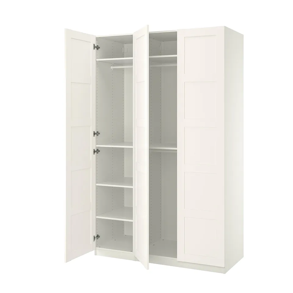 An open white ikea PAX wardrobe with adjustable interiors and soft-closing hinges.