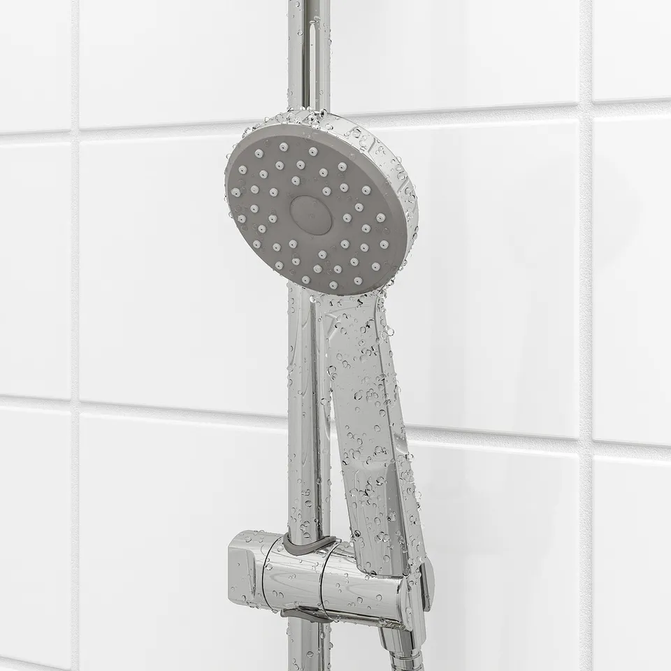 Hand shower with comfy full spray. Adjustable height. Water and energy saver. Chrome finish. Tiled wall background.