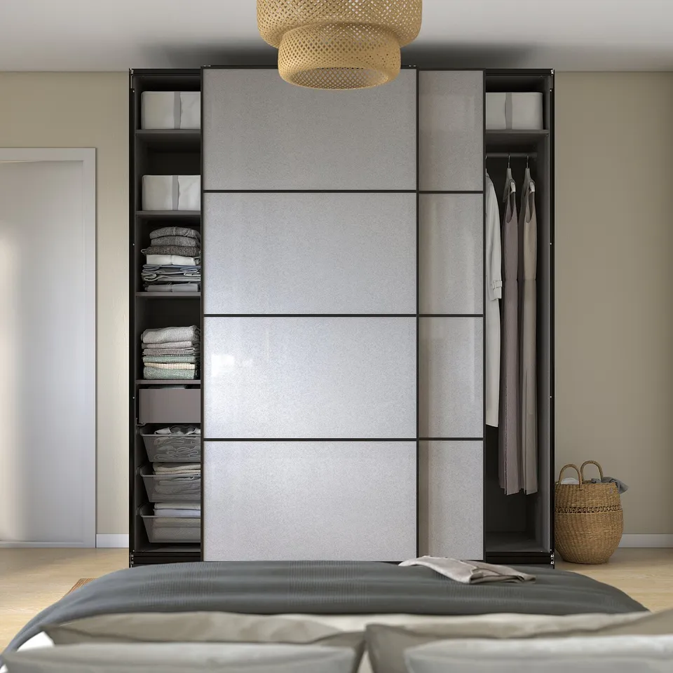 Neat bedroom with grey wardrobe, sliding doors, and shelves storing clothes and toys.