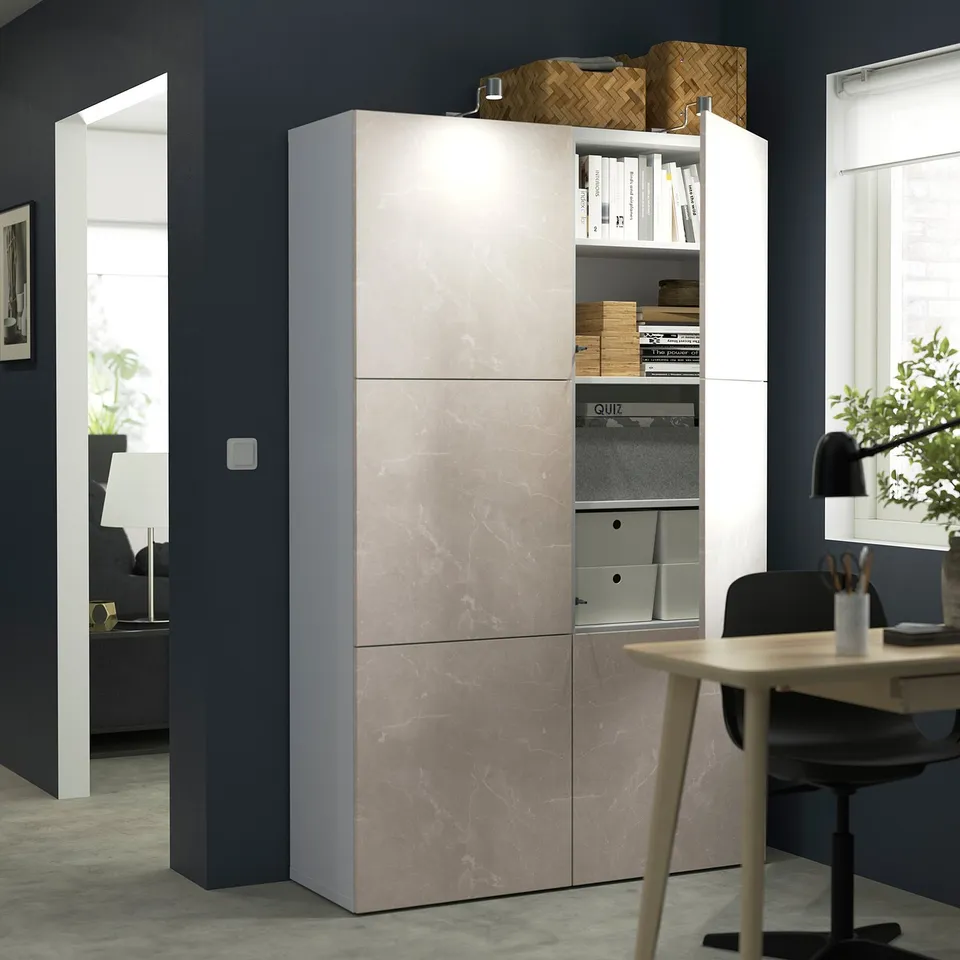 Modern office with BESTÅ storage unit featuring adjustable shelves and soft-closing doors, displaying books and organisational boxes.