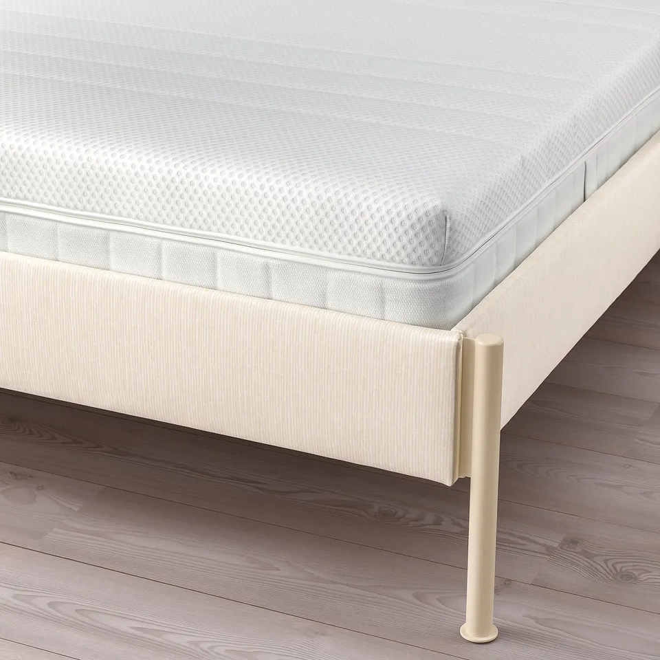 Clean-lined bed frame with adjustable sides, designed to fit various mattress thicknesses, promoting easy cleaning and storage beneath.
