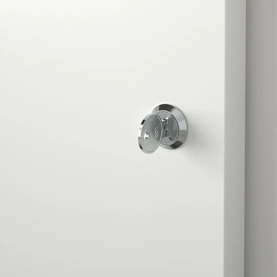 Close-up of a shiny, round metal lock on a smooth white door, reflecting light, indicating high quality.