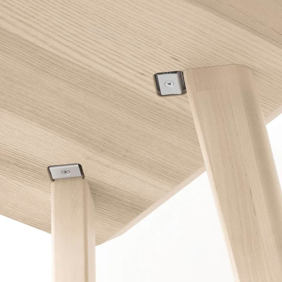 Wooden table detail: durable ash veneer top, sturdy birch legs, metal screws ensure stability.