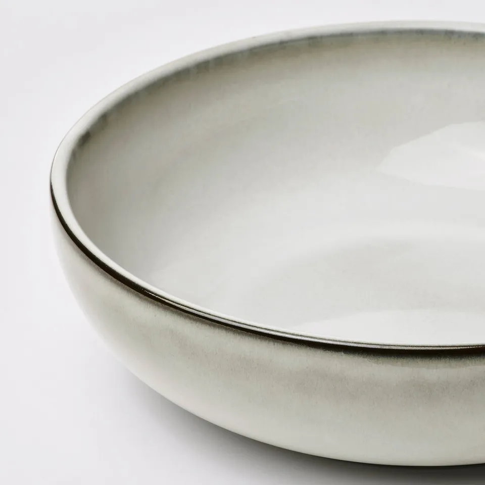 Shallow oven dish with a smooth, glossy hearty glaze. Rounded edges, pristine surface, and fine craftsmanship evident.