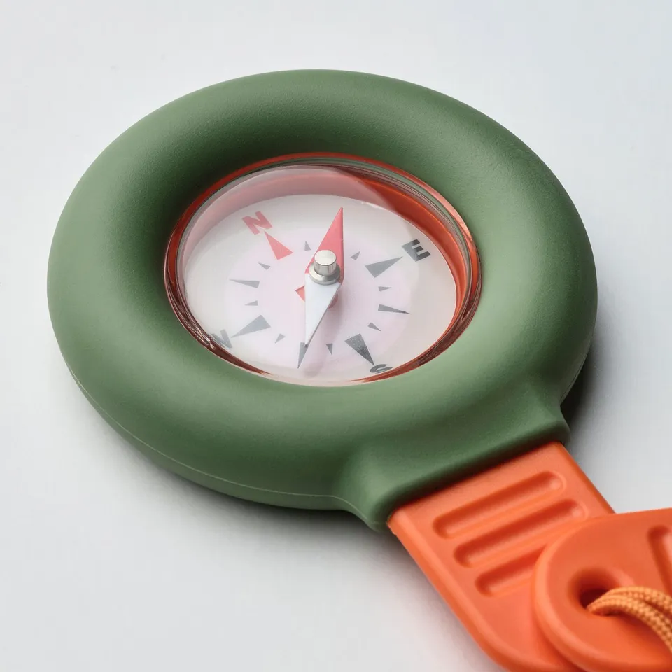 Compass with green base and orange strap, durable for kids adventures.
