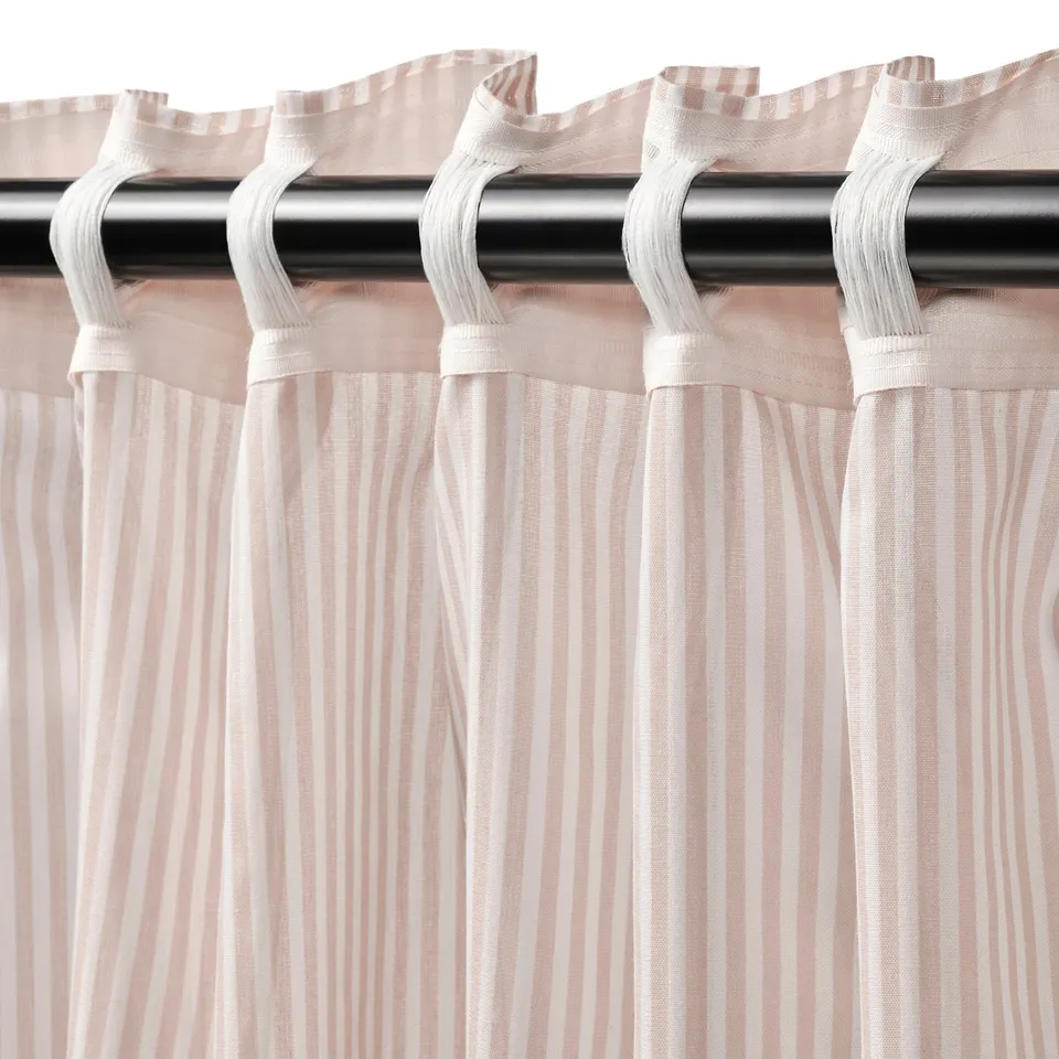 Curtains with white heading tape hang from black rod, offering privacy and light diffusion.