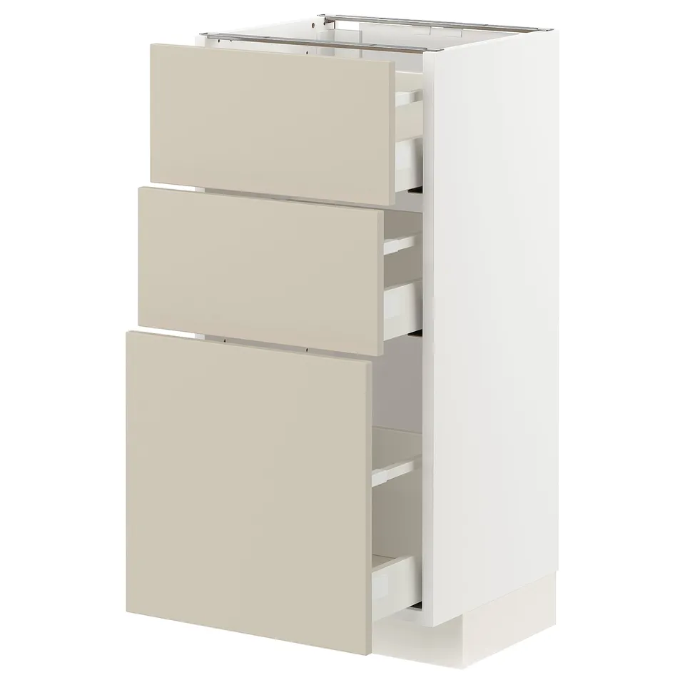 A white ikea METOD kitchen cabinet with three beige drawers. The cabinet a sleek, modern design with smooth-running drawers.