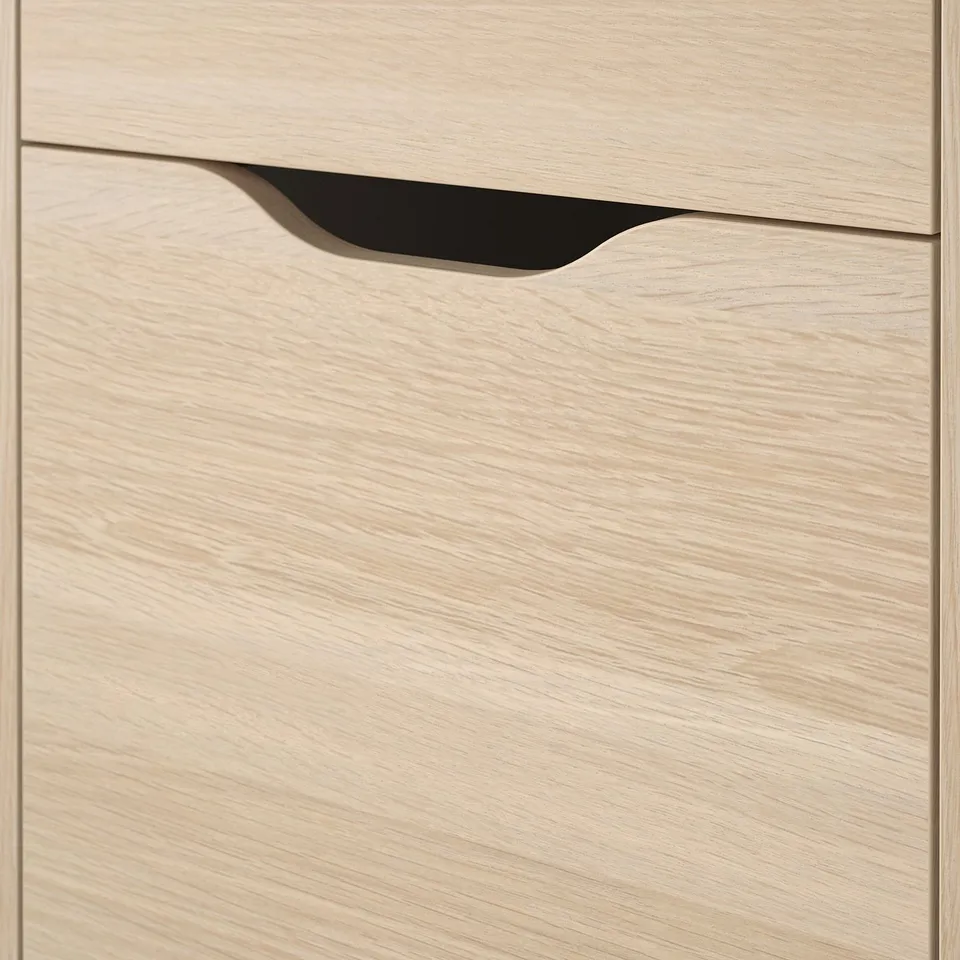 Close-up of ALEX drawer units smooth, light wooden finish with cutout handle.