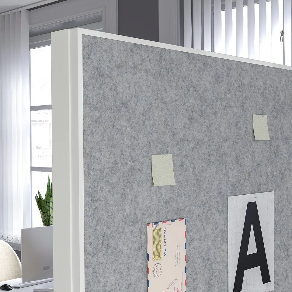 Office partition with whiteboard and pinboard. Includes storage shelves for markers and notes.