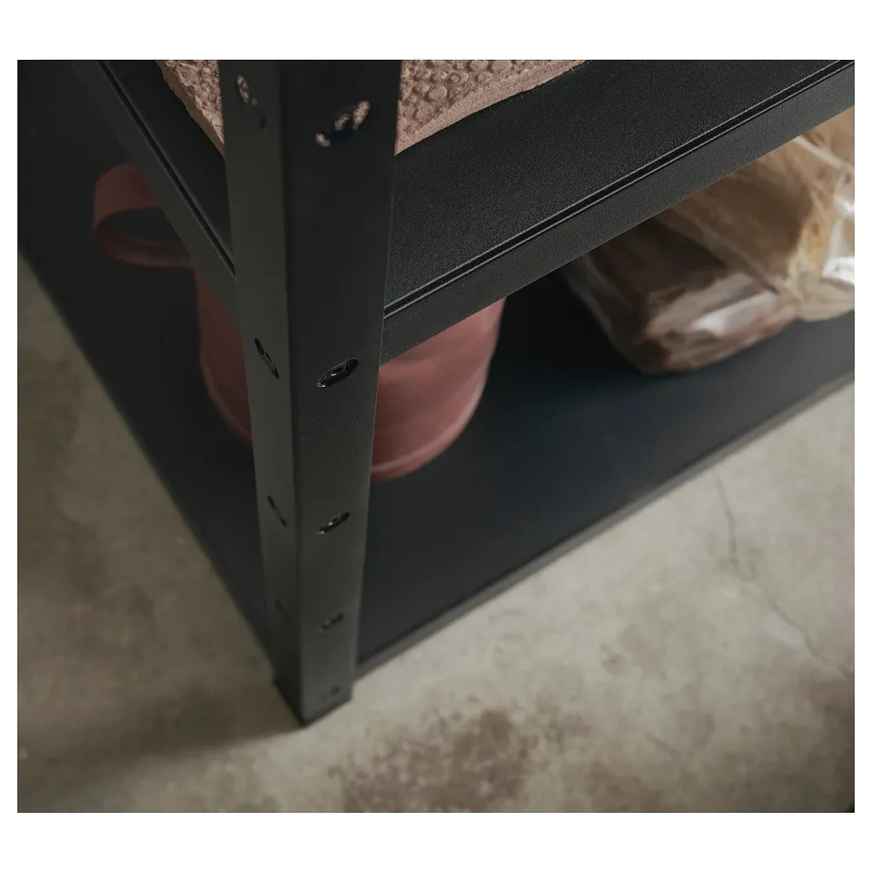 Black metal shelf unit with pink items stored.