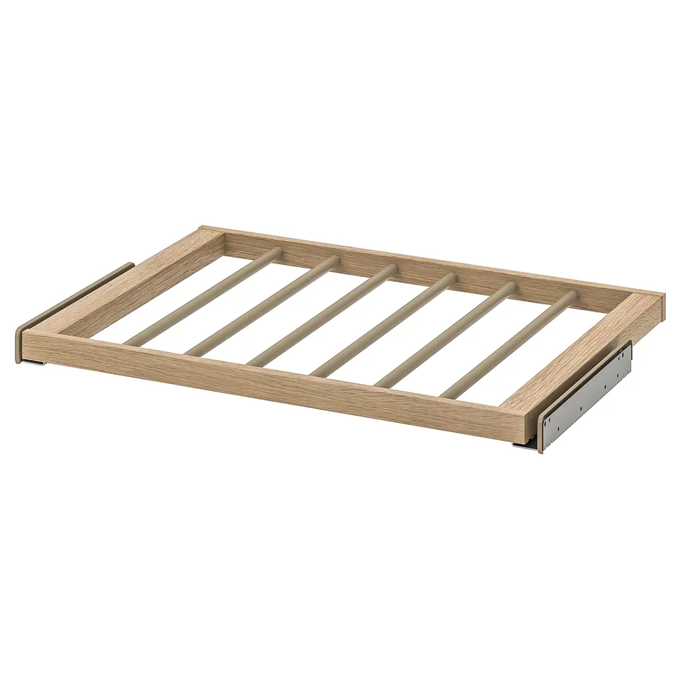 A KOMPLEMENT wooden trouser hanger in natural colour, featuring a rectangular frame with metal brackets.