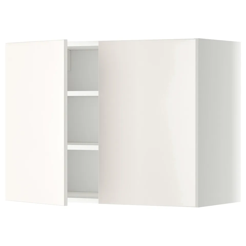 White wall-mounted kitchen cabinet with one open door, revealing two shelves.