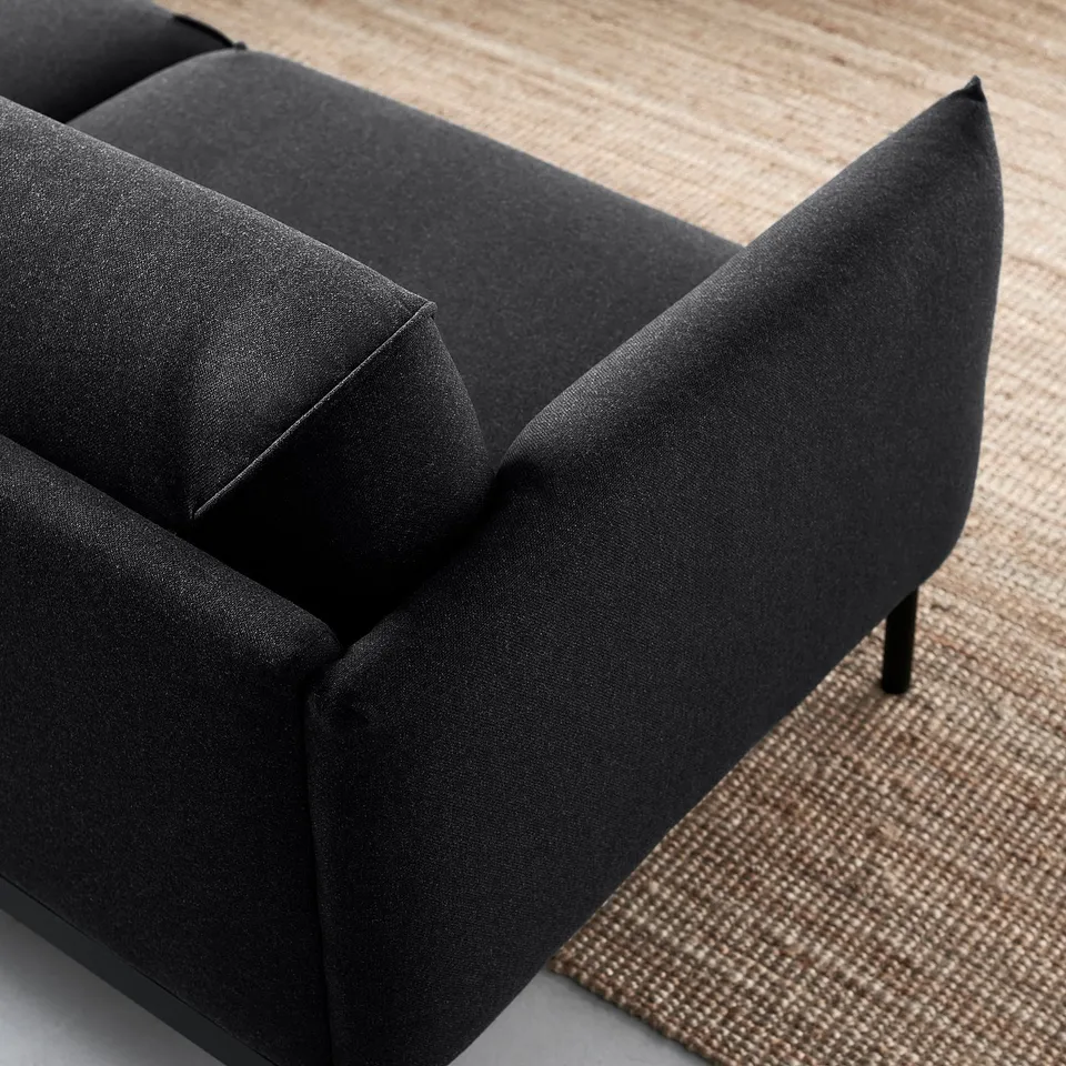 Black sofa, modern & durable in living room.