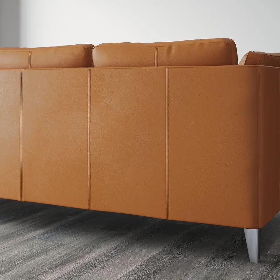 Modern sofa with tan aniline leather, boxy cushions, and metal legs.