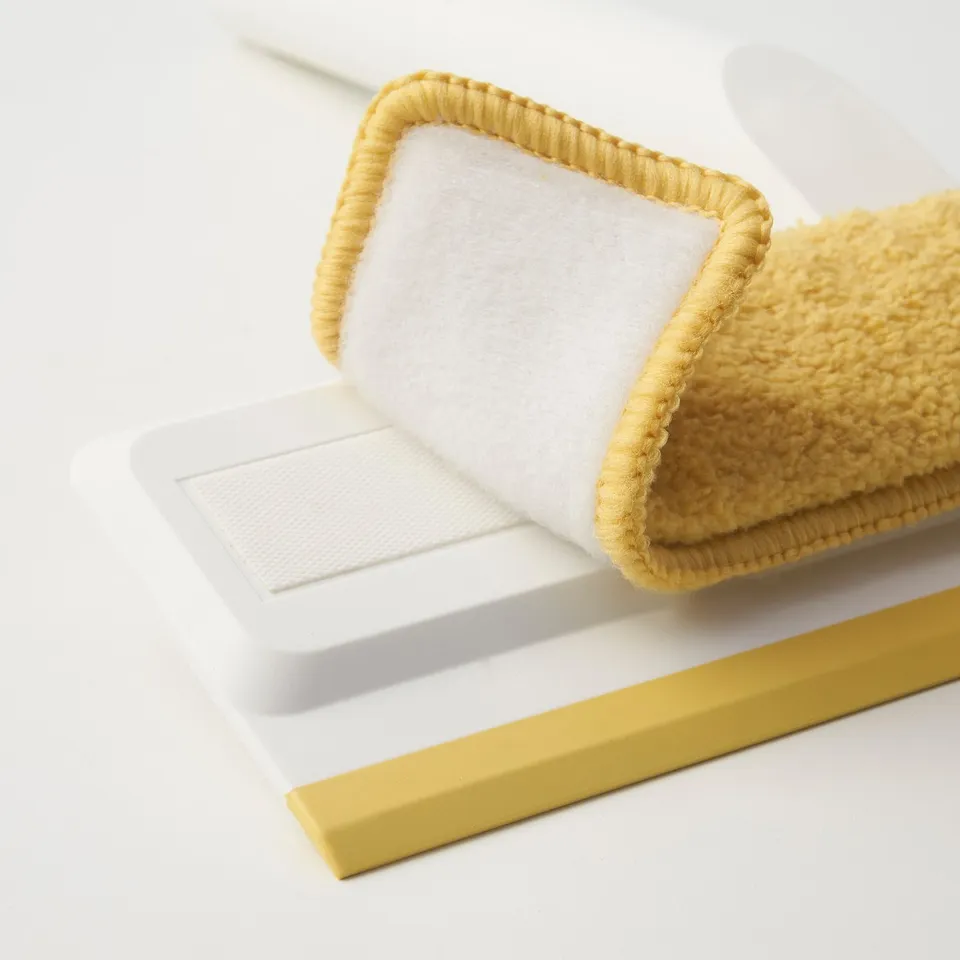 Yellow PEPPRIG cleaning pad & holder on white background. Soft, absorbent, easy to attach.