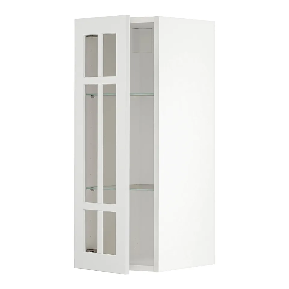 A white METOD kitchen cabinet with frosted glass doors. It a modern design with two shelves inside.