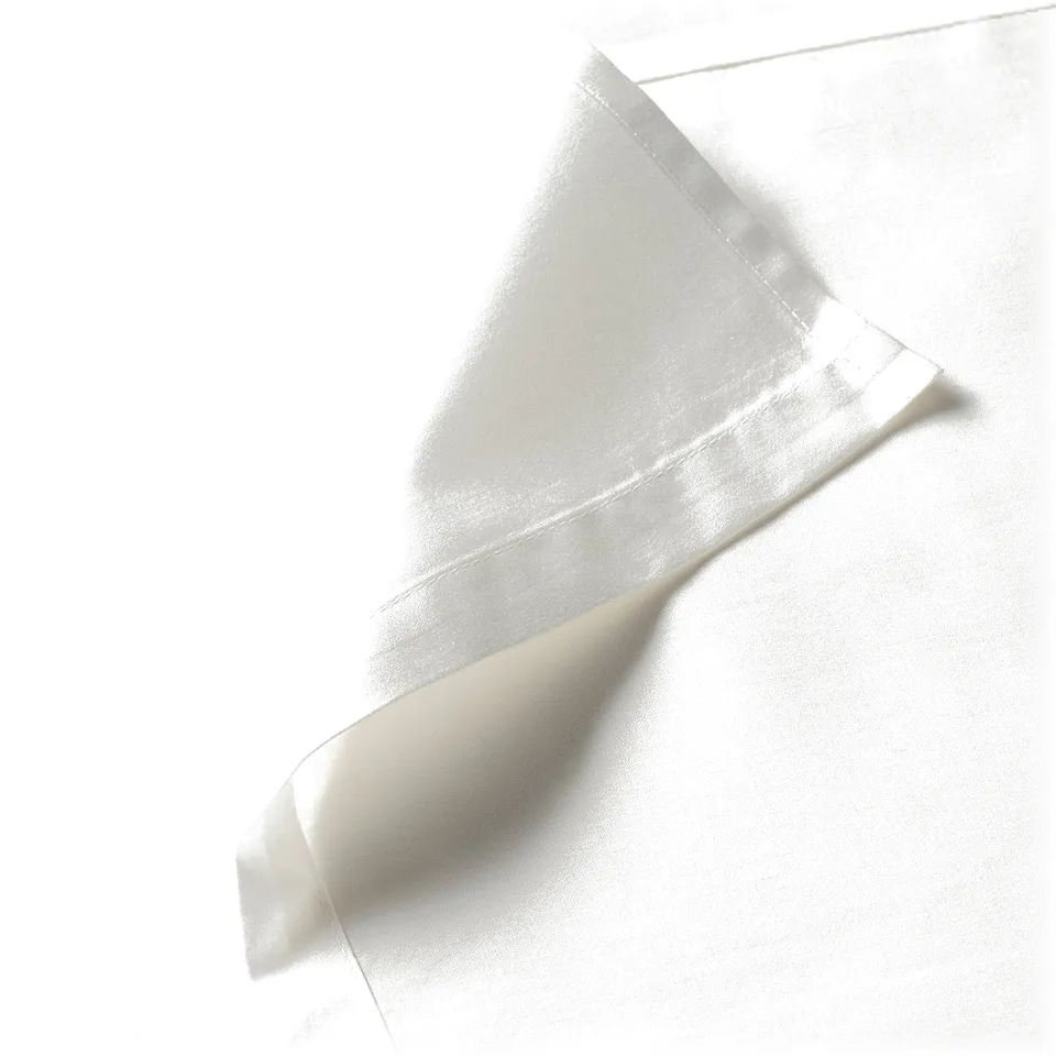 Elegant sheet corner with smooth, lustrous fabric.