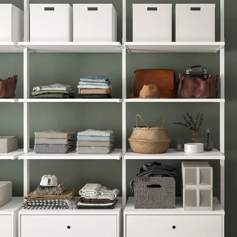 Modern shelving unit with clothes, bags, and baskets. Adjustable areas for organisation.