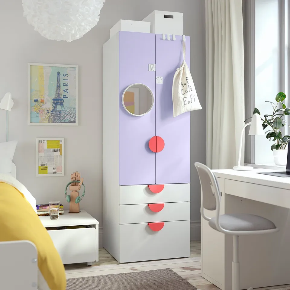 Kids room with SMÅSTAD wardrobe, pink pulls, paris poster, desk, chair, lamp, plant.