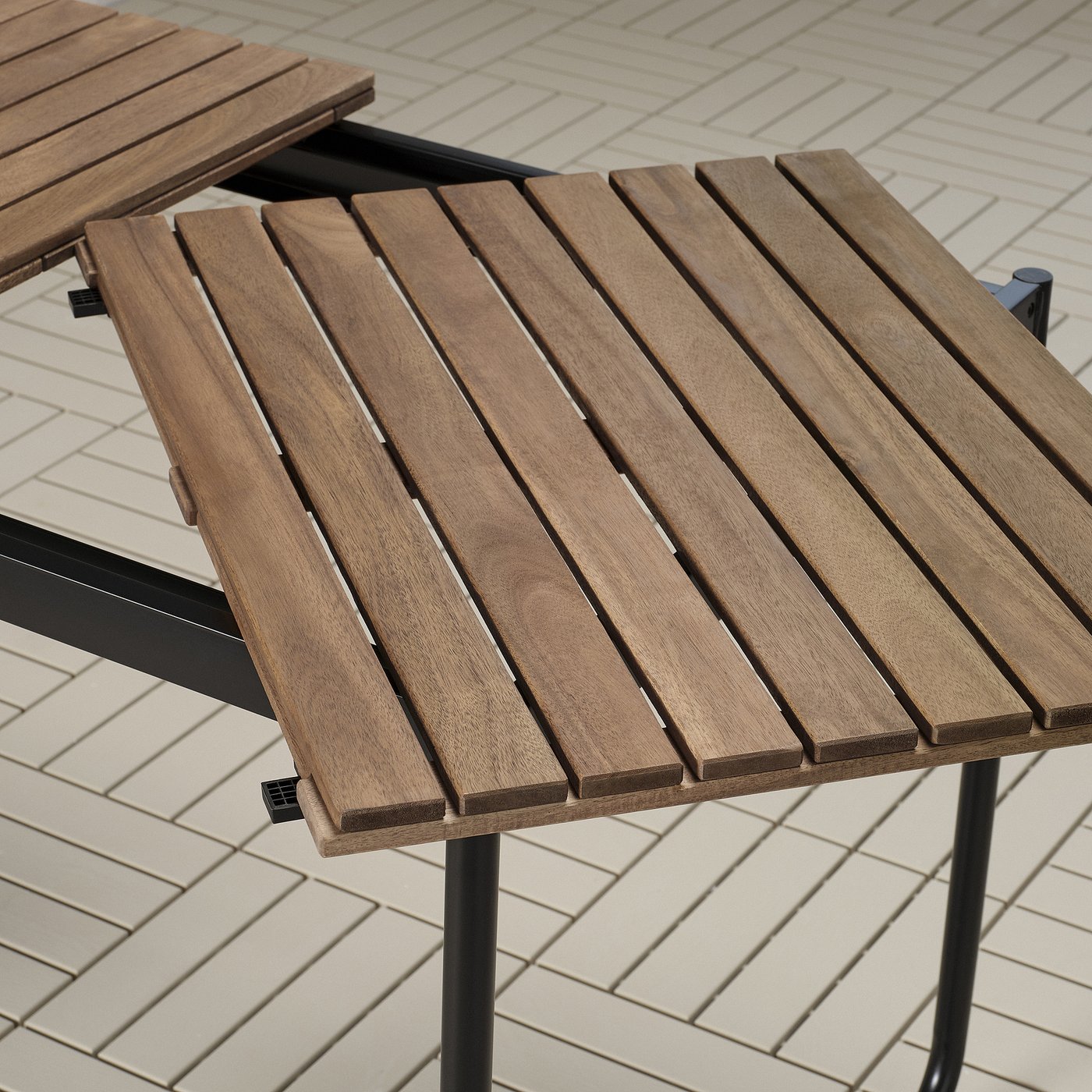 Wooden outdoor table with metal legs, featuring a slatted, natural-finished top, designed for durability and ease of use.