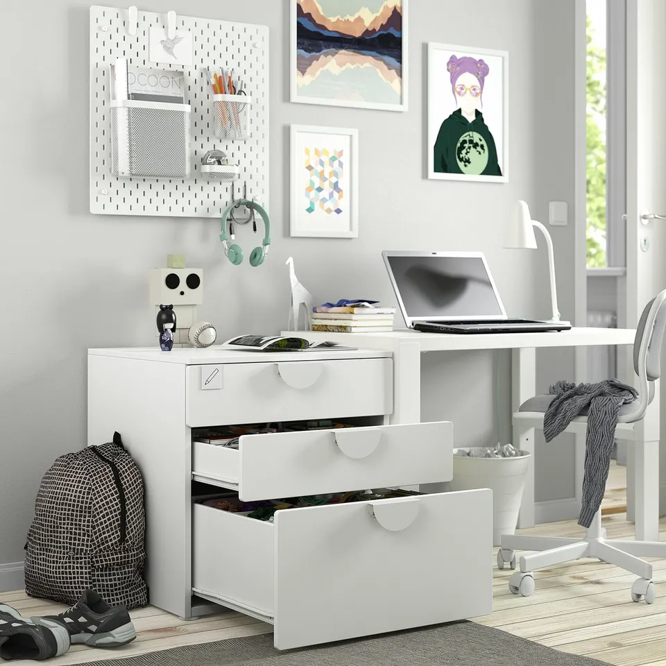 Desk with open laptop, drawers, and backpack, showcasing SMÅSTAD storage for kids.