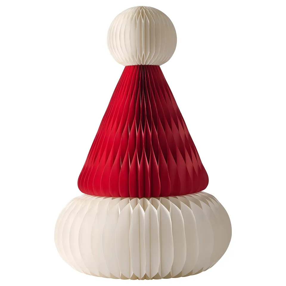 A festive decoration, the VINTERFINT, in red and white. Its cone-shaped with a round base and top, made of paper.