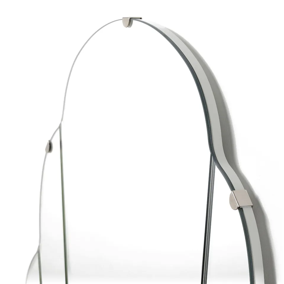 Modern wall-mounted mirror with sleek metal fitting, reflecting clean design.
