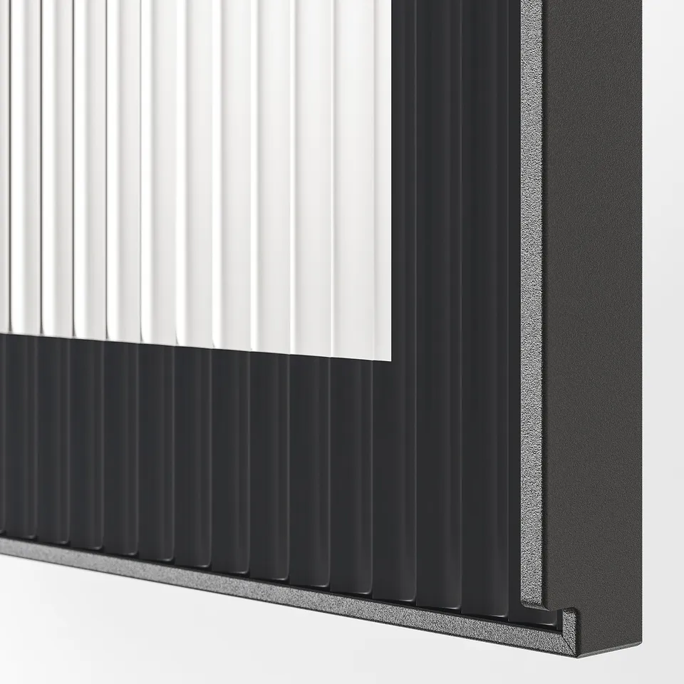 Closeup of modern HEJSTA glass cabinet door with fluted design; sleek black frame, textured glass.