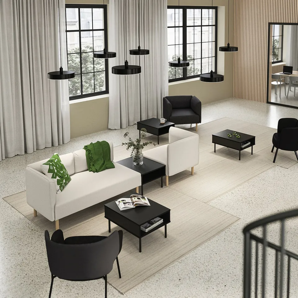 Modern living room with LILLEHEM white sofa, black coffee tables, chairs, and pendant lights. Large windows with curtains.