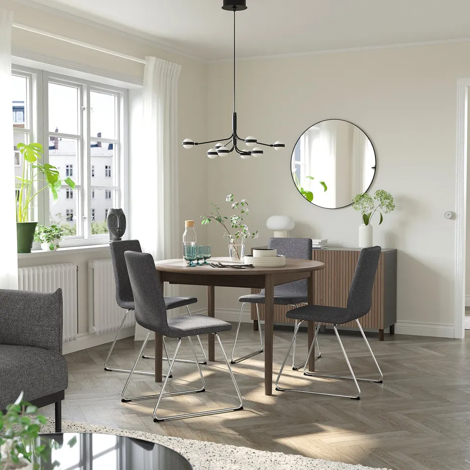 Modern dining area with SKANSNÄS 4-seat set, extending table, grey chairs, large window, pendant light, mirror, and herringbone floor.