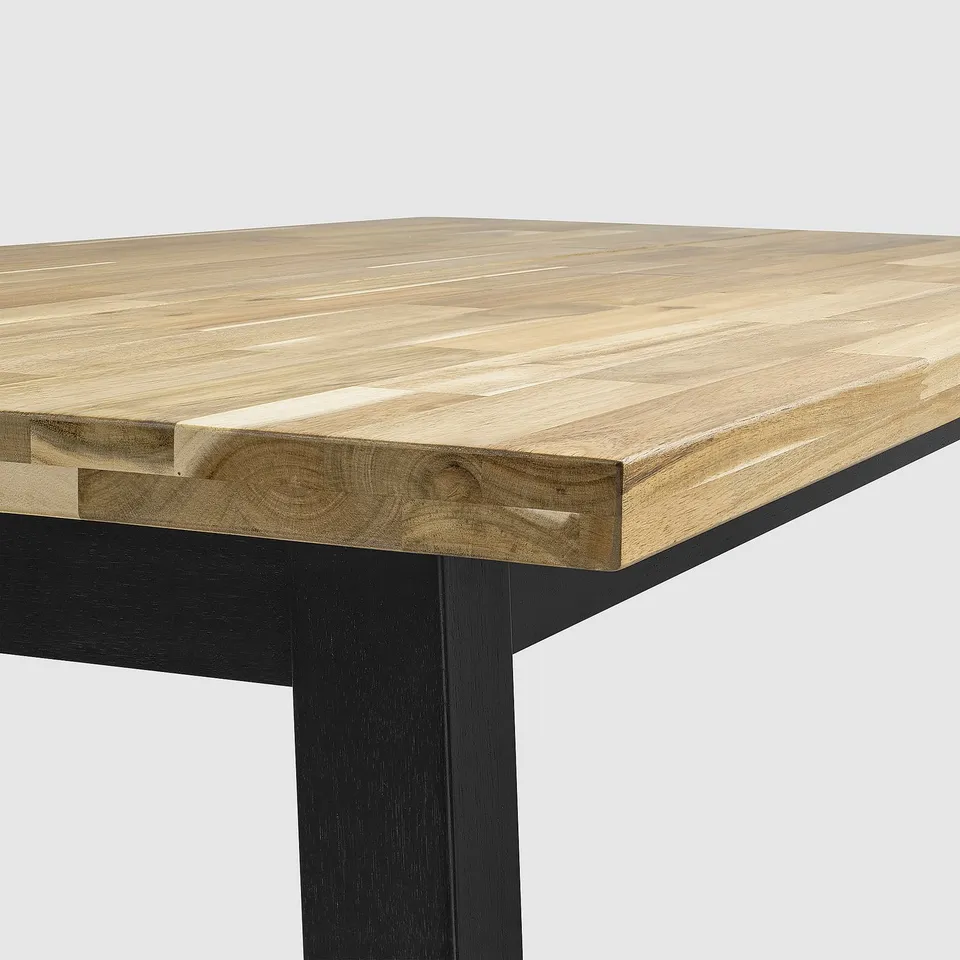 A sleek, modern table with a light wood top showcasing natural grain and a dark metal base.