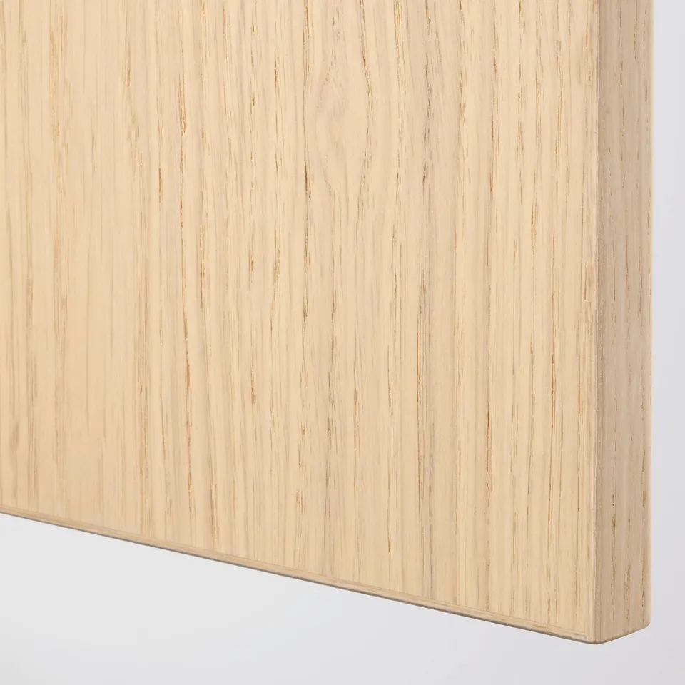 Close-up of smooth, light-colored wooden surface. Shows fine grain texture and clean, polished edge.