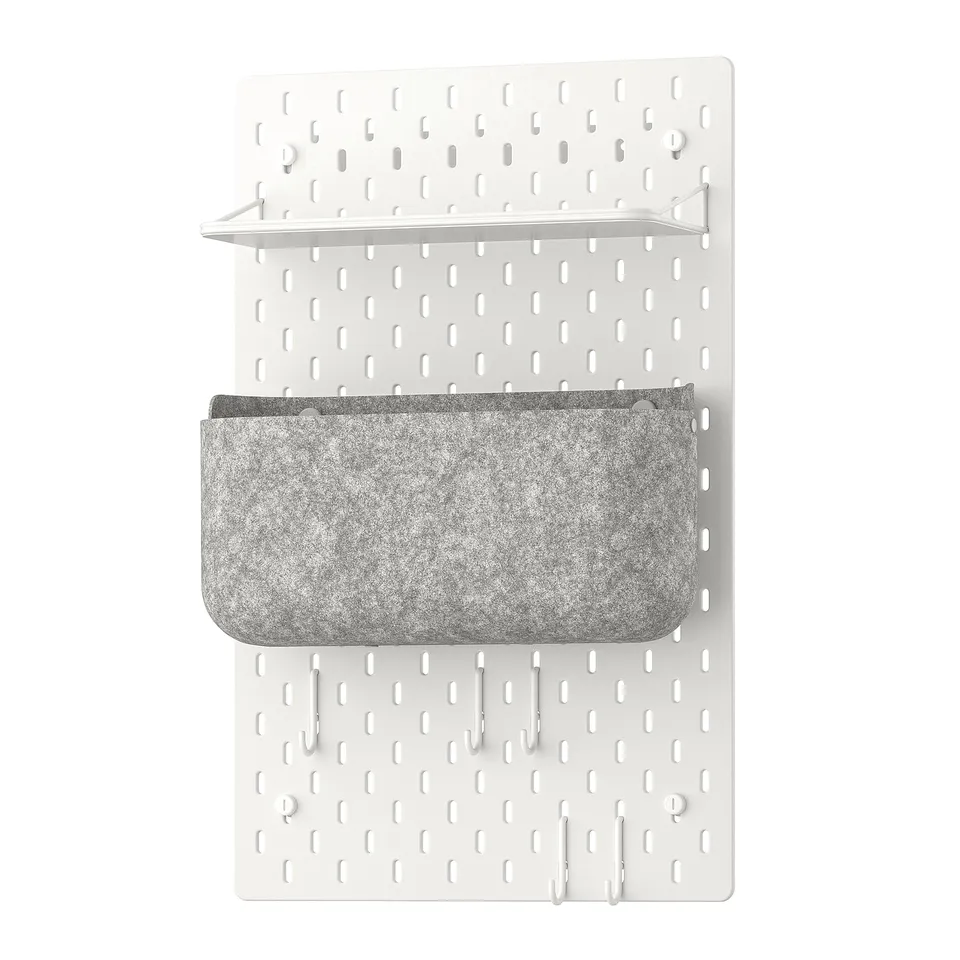 The SKÅDIS organiser a white pegboard with a grey fabric storage basket and metal accessories for wall organisation.
