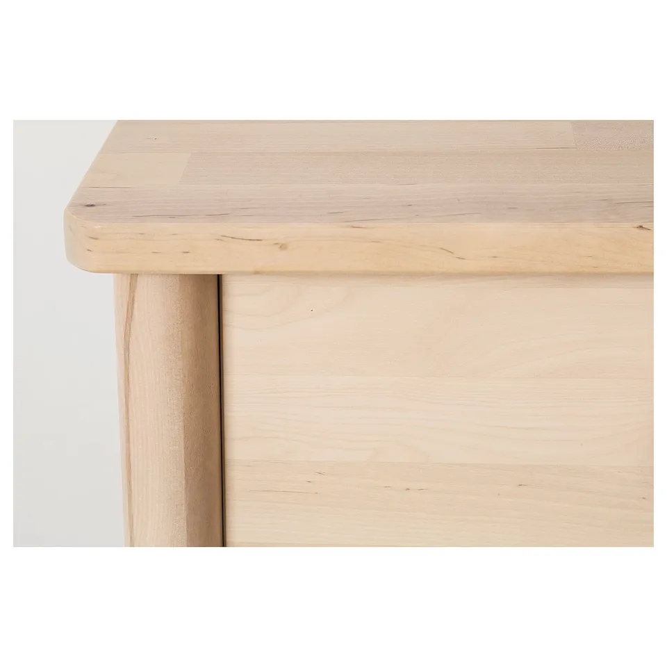 Natural wood table edge detail. Smooth, light finish. Rounded corner and flat surface.