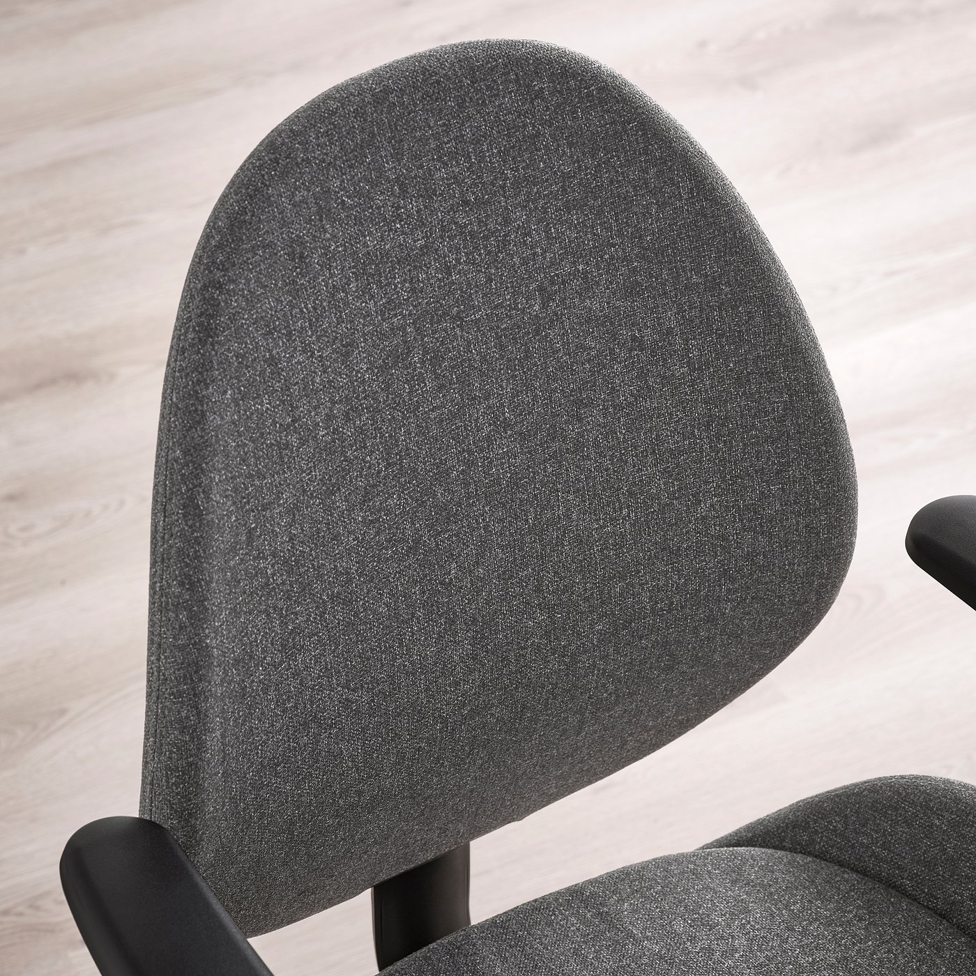 Close-up of modern ergonomic office chairs sleek, upholstered seat and armrest.