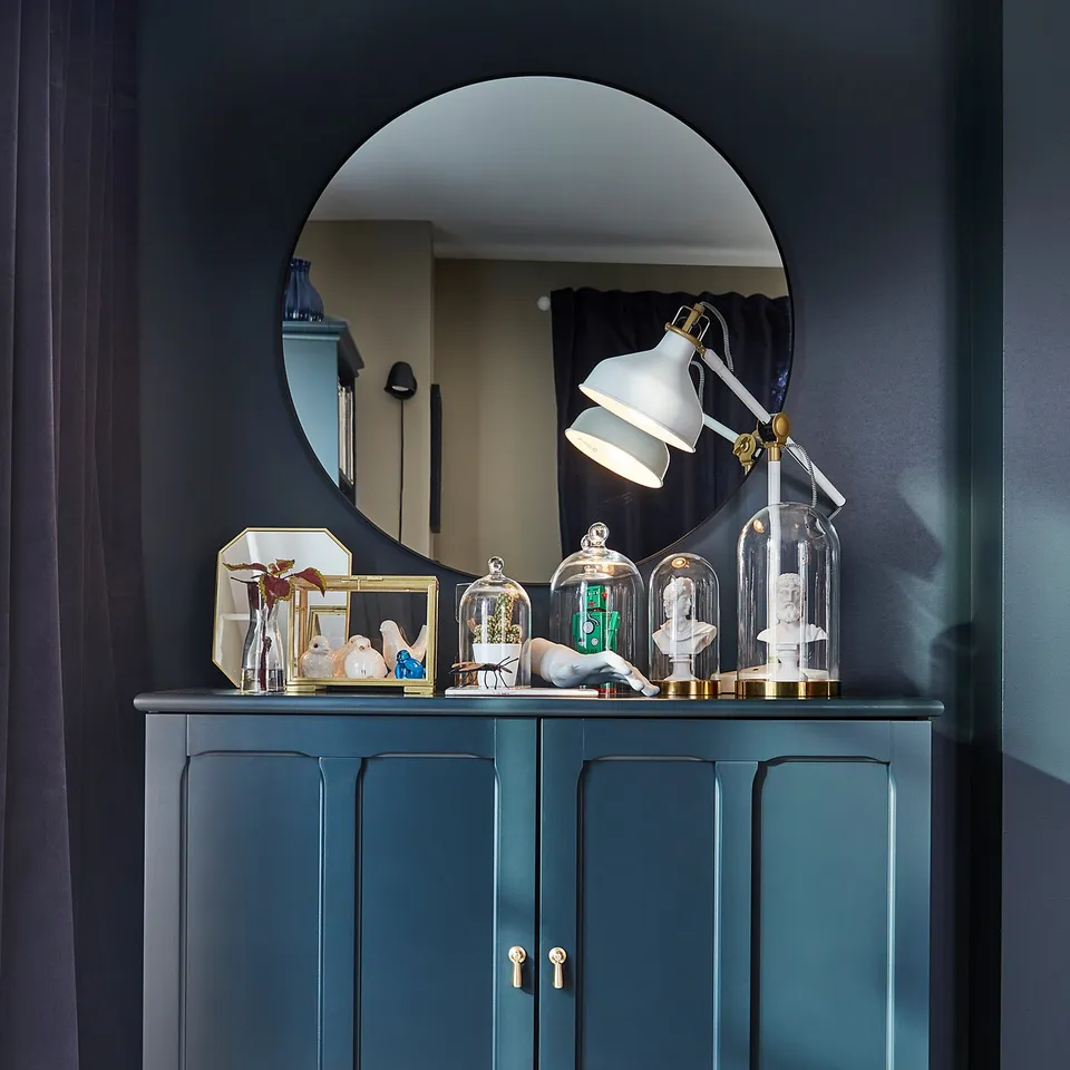 Dark green LINDBYN mirror cabinet with gold accents and glass domes.