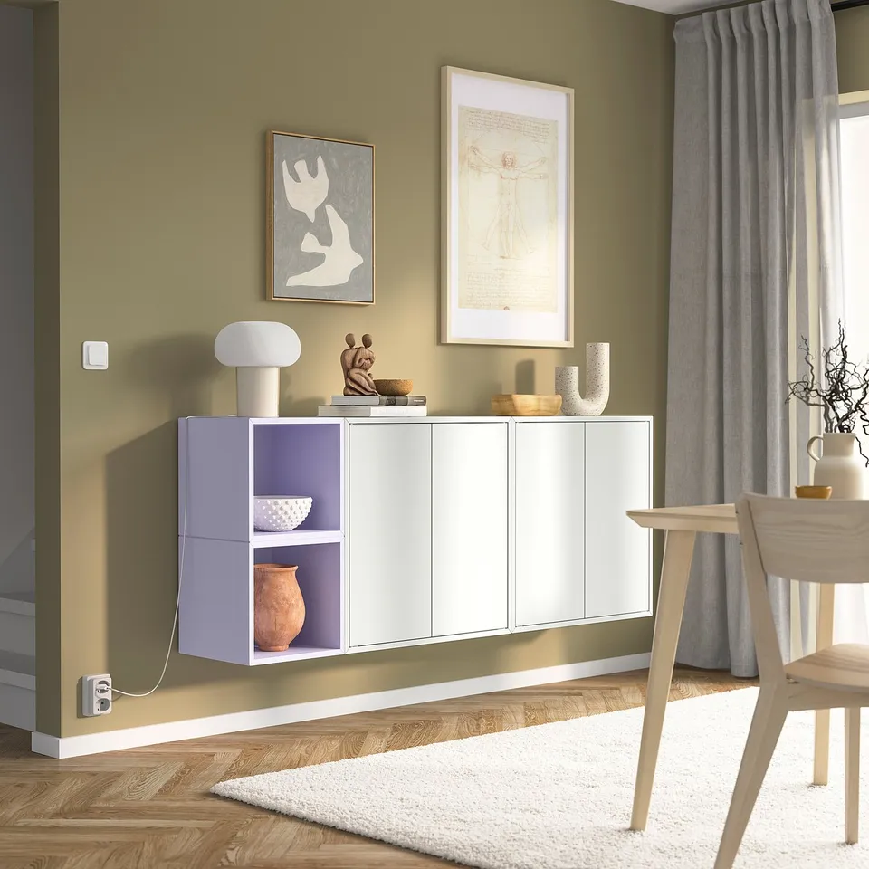 Modern living room with olive-green wall, wooden floor, EKET storage, and decor.