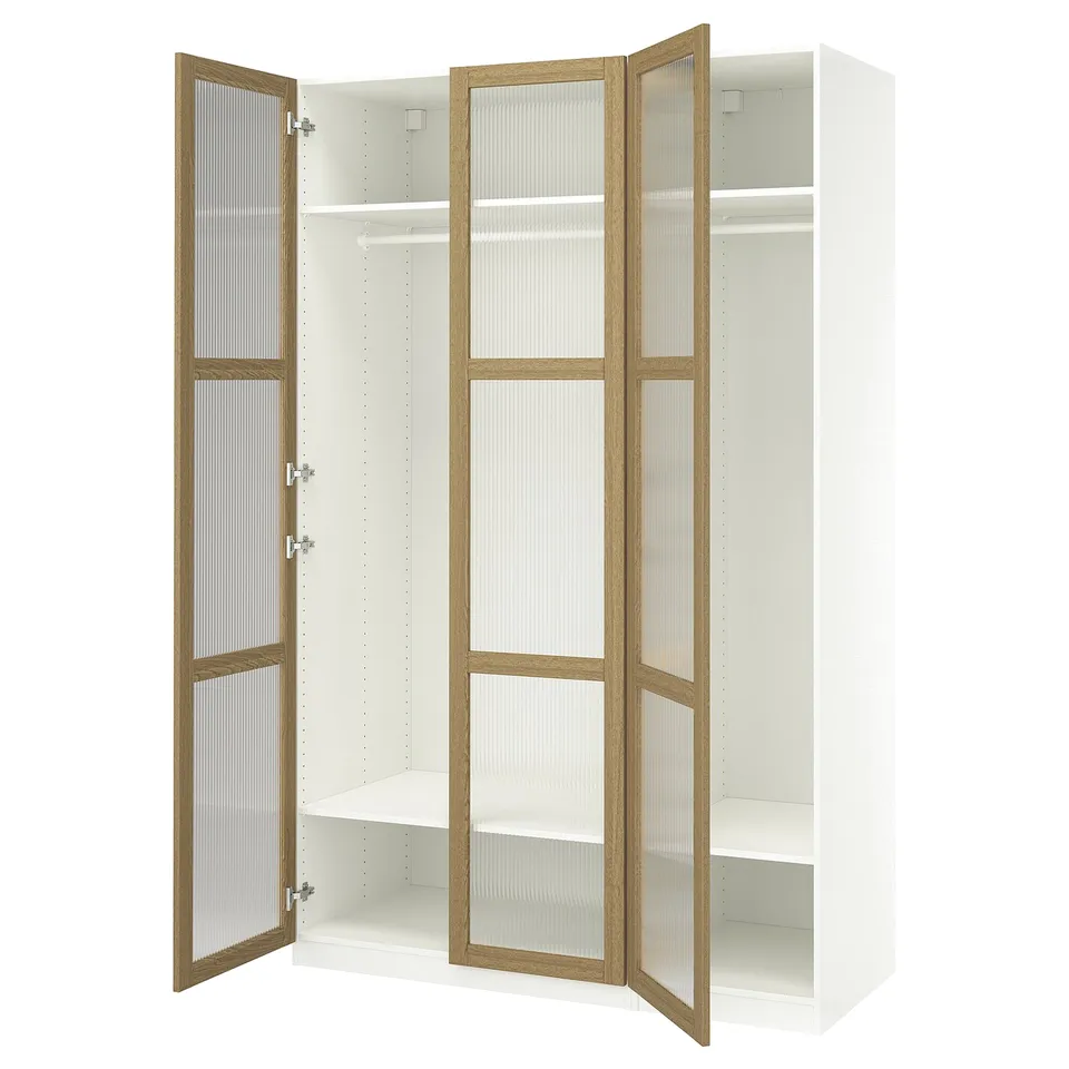 A white ikea PAX wardrobe with wooden-framed glass doors open, displaying a hanging rod and shelves inside.