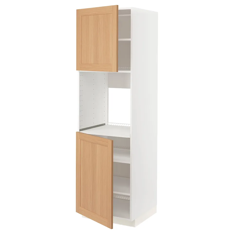 An ikea METOD kitchen cabinet with oak doors, standing tall and white, featuring adjustable shelves.