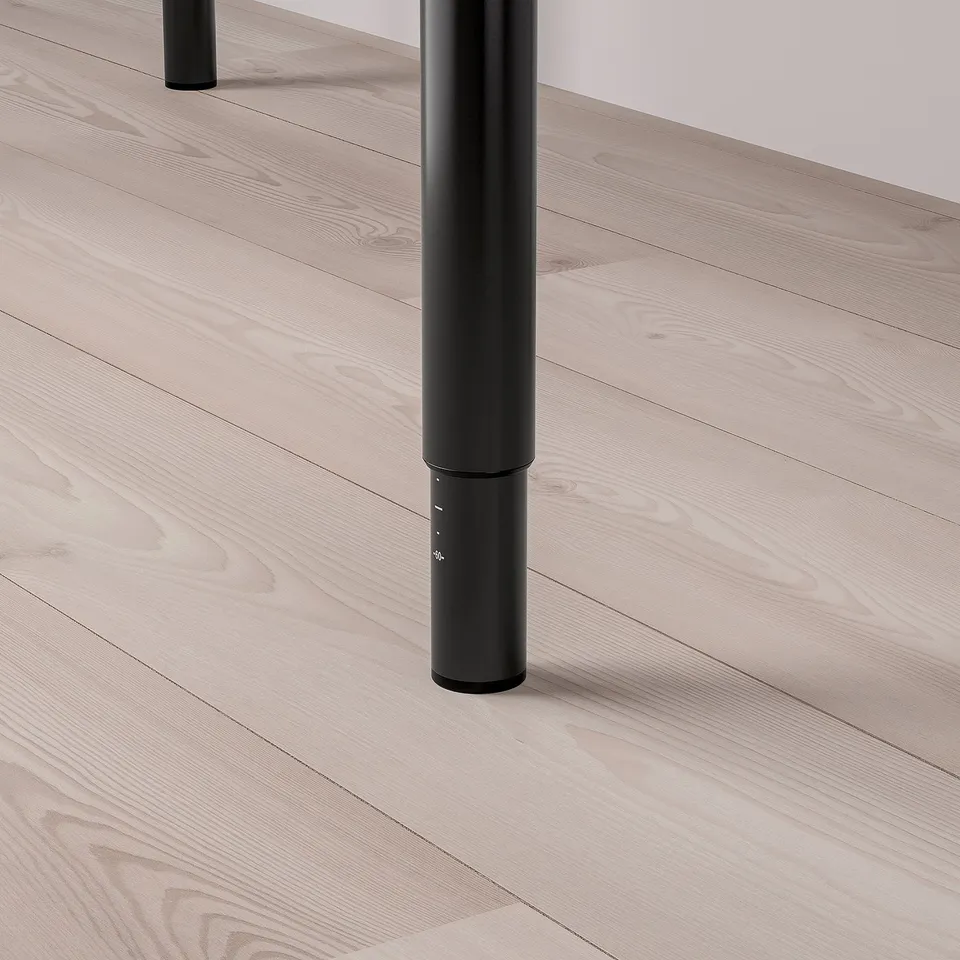 Black adjustable leg attached to light wooden floor, showcasing sturdy and modern design.