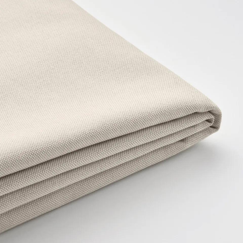 Folded beige fabric, smooth texture, uniform weave, neatly pressed.