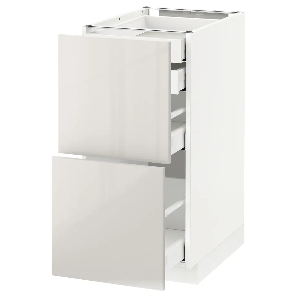 White METOD kitchen cabinet with high-gloss finish and multiple drawers.