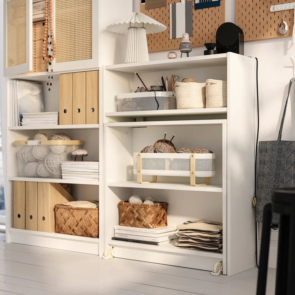 Modern shelf setup with mix of open and closed storage, featuring a fold-out table and wooden accents, displaying crafted items and books.
