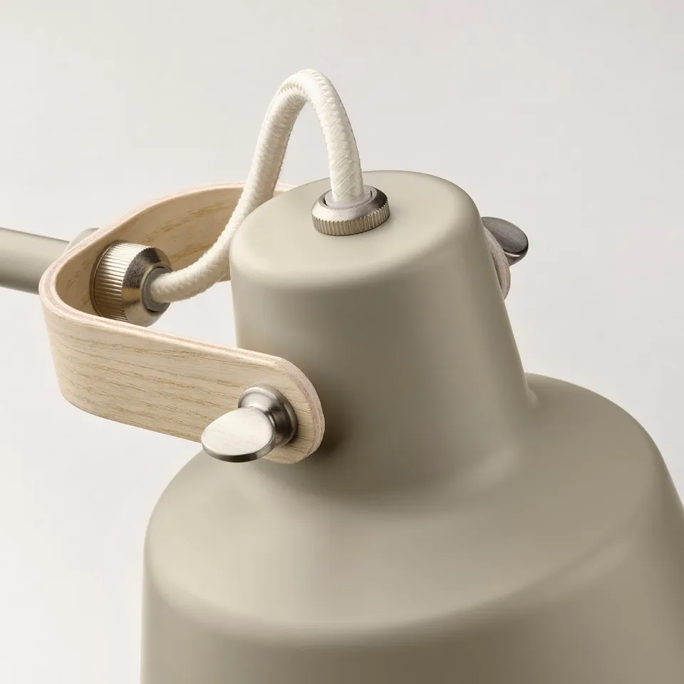 Modern desk lamp with adjustable metal shade and wooden handle, featuring a sleek design and quality finish.