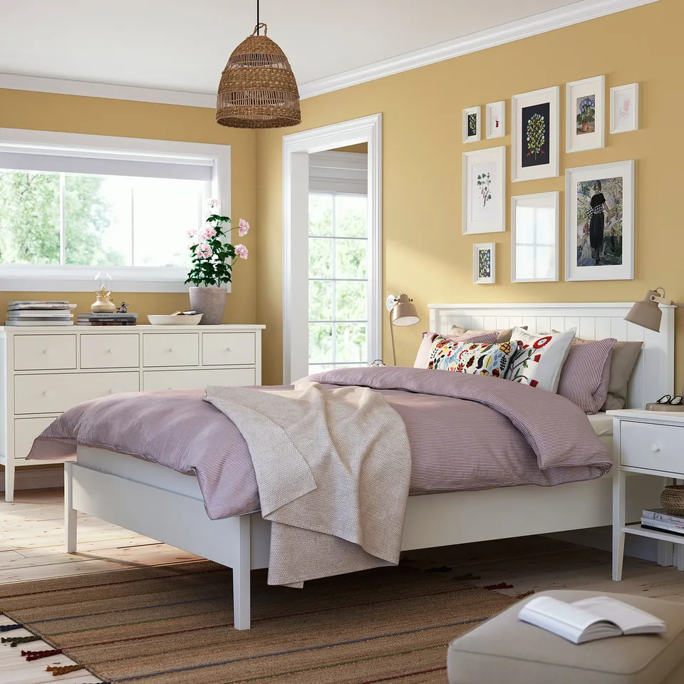 Bright bedroom with GULLABERG bed, pastel linens, white furniture, wall art.