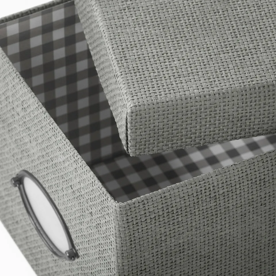 Open woven paper storage box with chequered inner lining and handle.