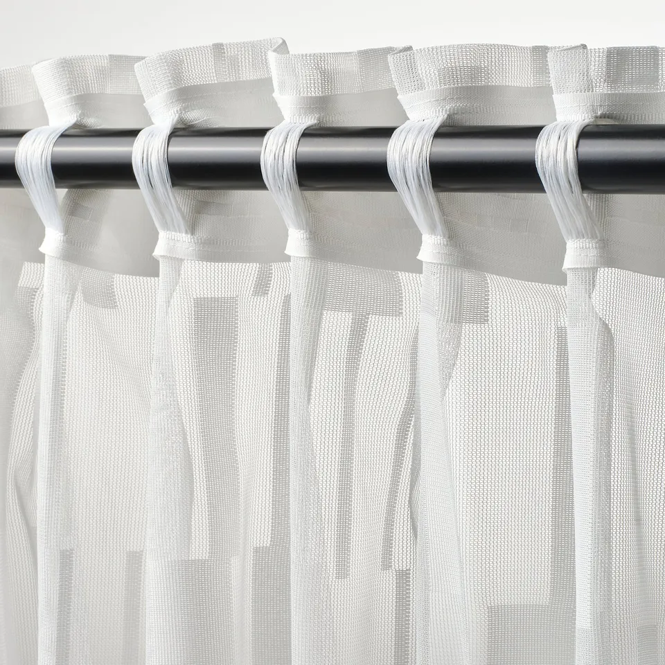 Sheer curtains with multi-header design hang from rod, allowing use of hooks or direct rod pocket for flexible mounting.
